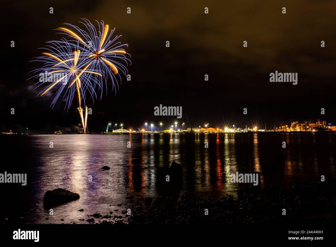 Colour night time photograph of public fireworks display, celebrating Guy Fawkes night on Poole quay, Dorset, England. Stock Photo