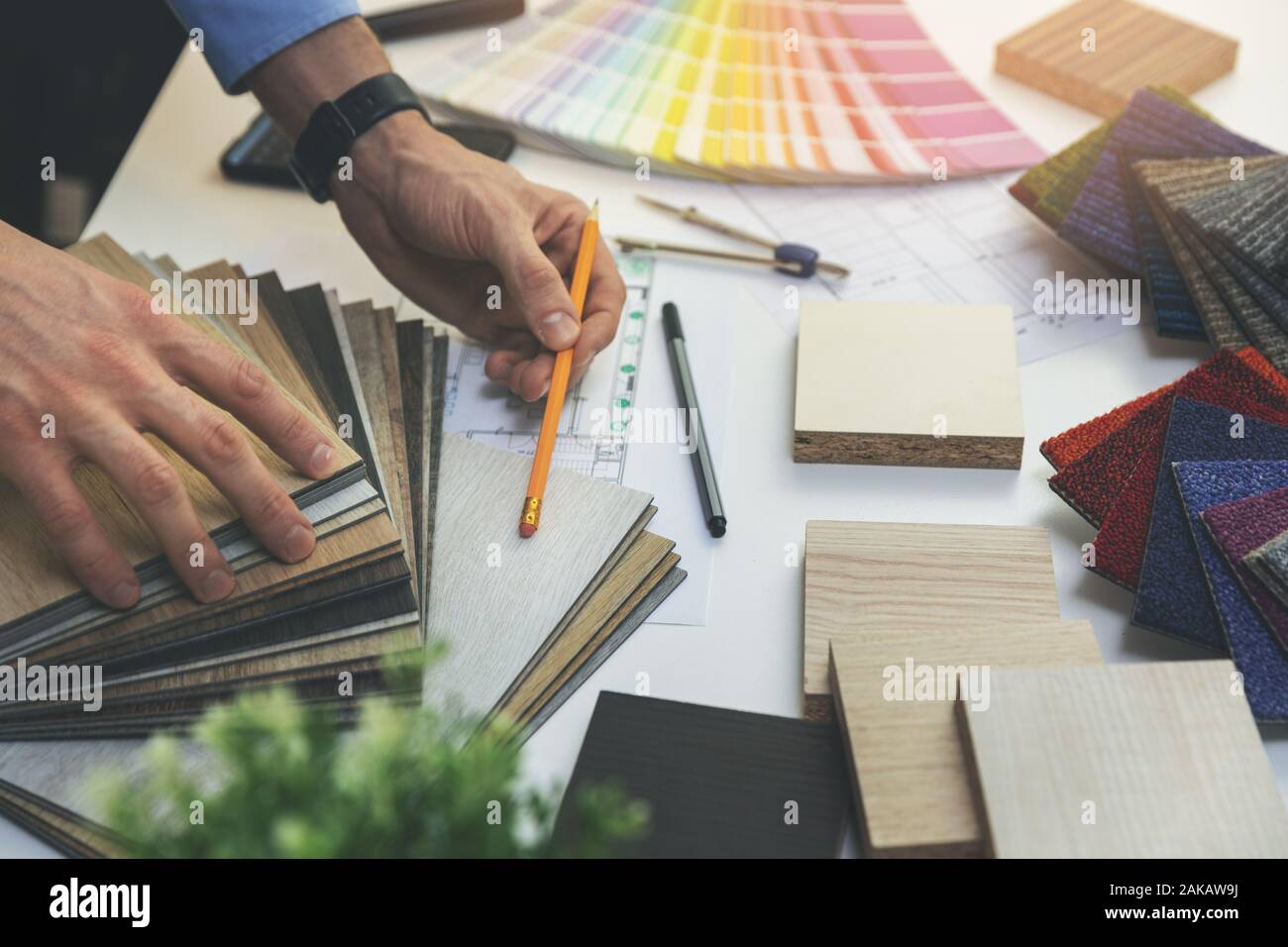 designer choosing flooring and furniture materials from samples for home interior design project Stock Photo