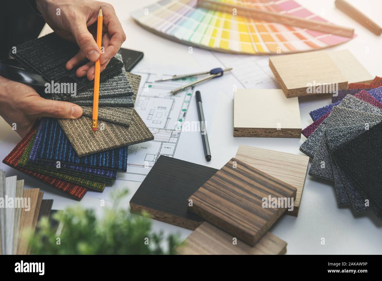 designer choosing flooring and furniture materials from samples for home interior design project Stock Photo