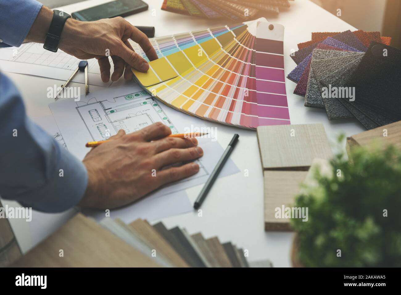 designer choosing paint color from swatch for home interior design project Stock Photo