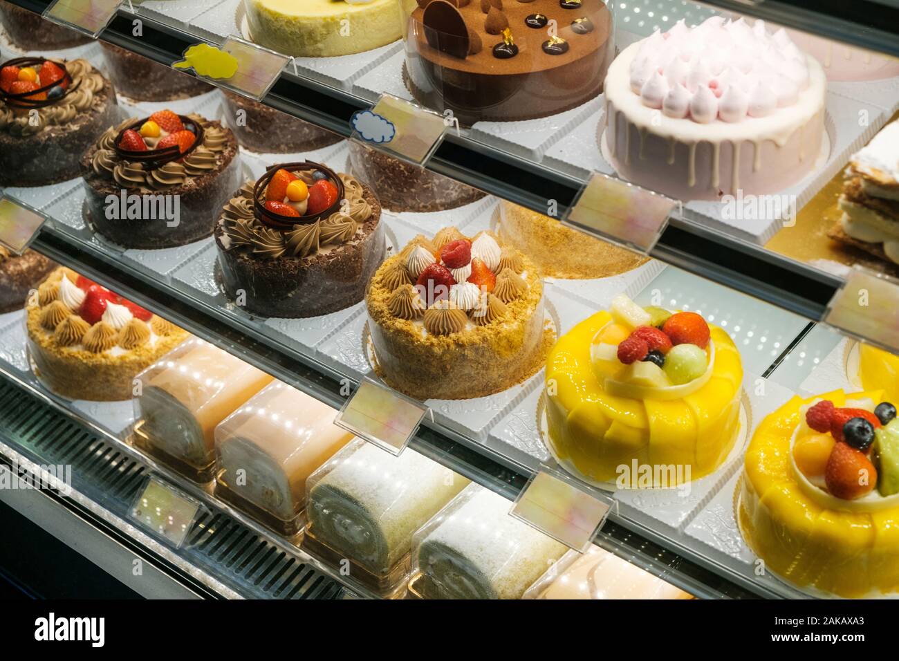 sweets and cakes on display in bakery shop Stock Photo Alamy