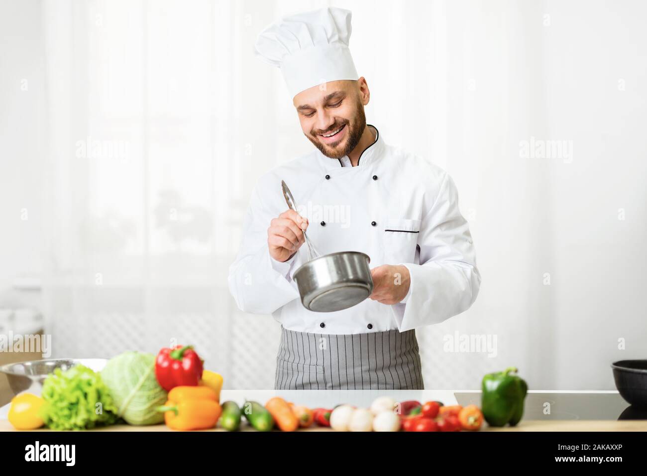 Male Chef Using Wire Whisk Mixing Ingredients In Saucepan Making Sauce ...