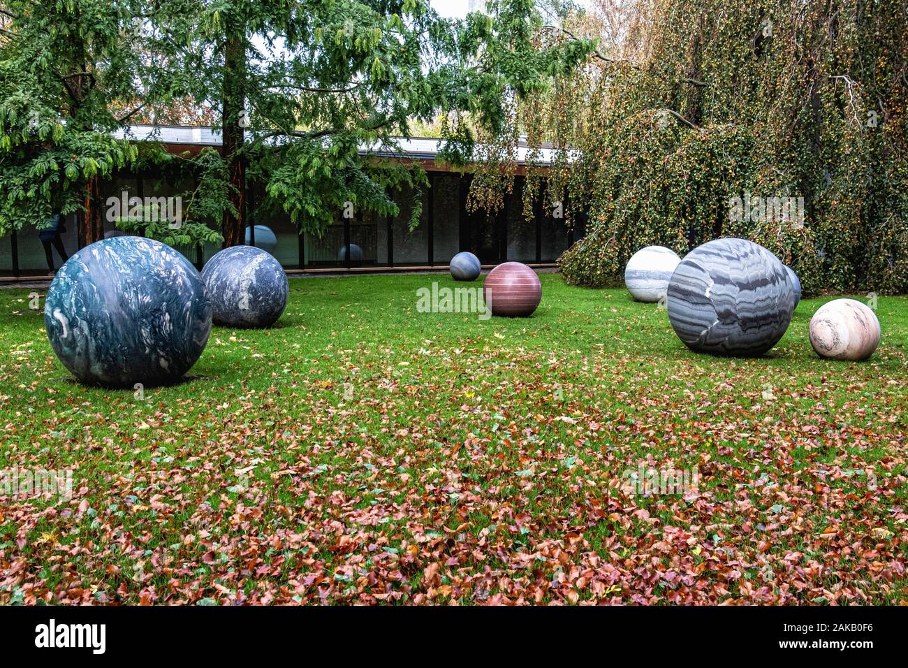 8 Stone Globes Perfectly Round sculpture by Sculptor Alicja Kwade in garden of Louisiana Museum