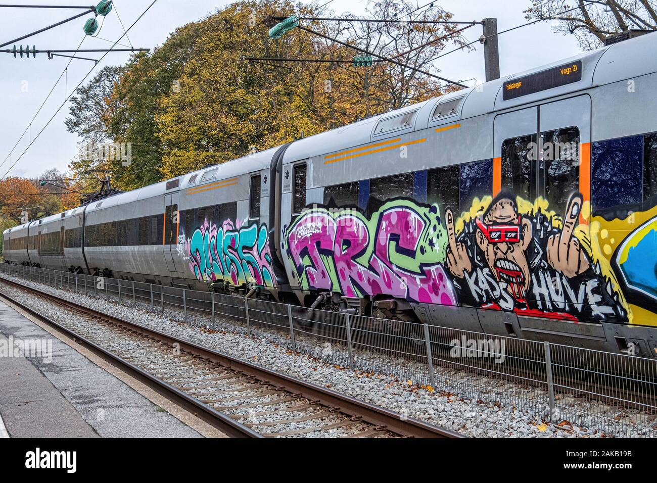 Graffiti-covered railway train at Humlebæk railway station in Humlebæk,North Zealand, Denmark. Stock Photo