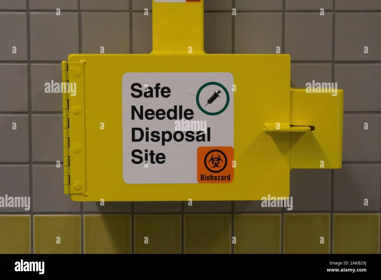 Safe medical needle disposal container on a toilet wall Stock Photo Alamy