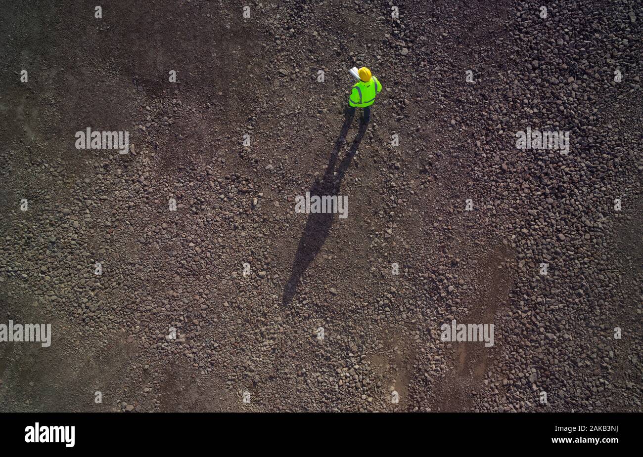 Birds eye view of a construction worker on gravel. Stock Photo
