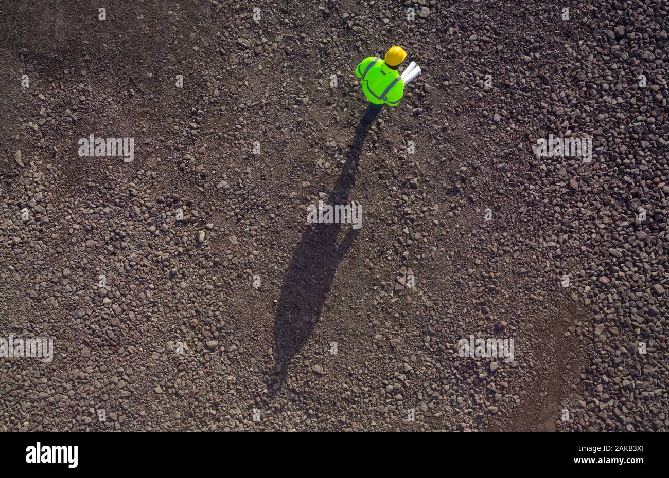 Construction worker on gravel from above. Stock Photo