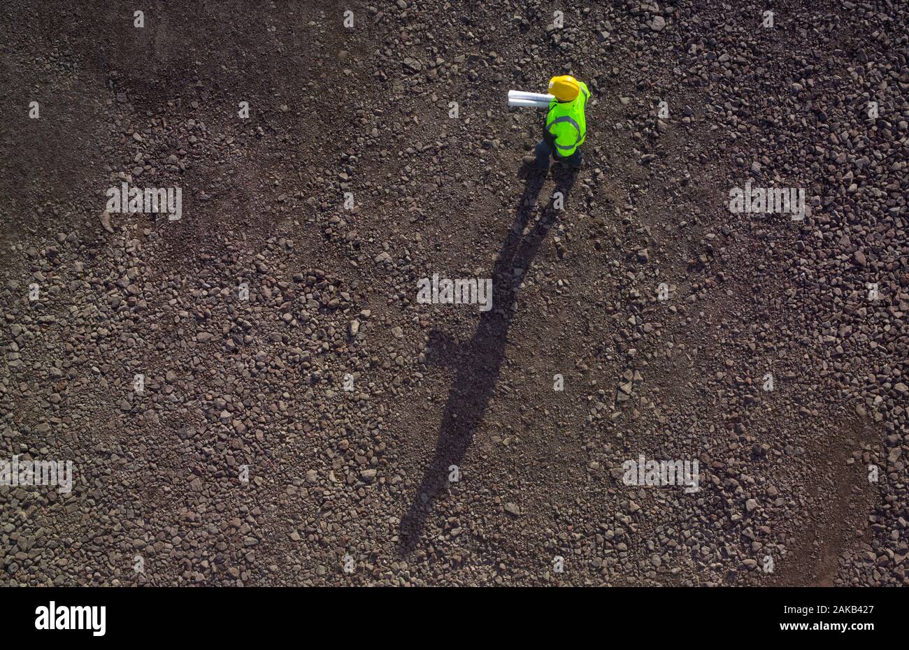 Construction worker on gravel from above. Stock Photo