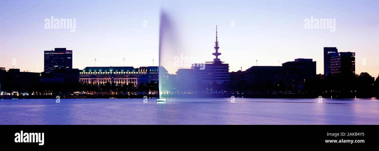 Fountain in Inner Alster Lake at dusk. Hamburg, Germany Stock Photo