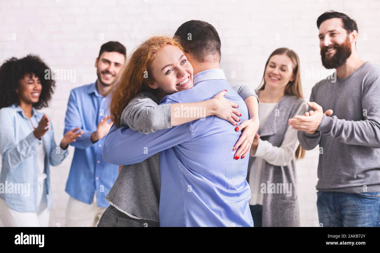 Positive happy people hugging each other at rehab group meeting, panorama  Stock Photo - Alamy