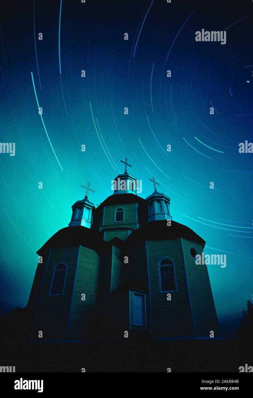 Russian Orthodox Church under star trails at night, Andrew, Alberta, Canada Stock Photo