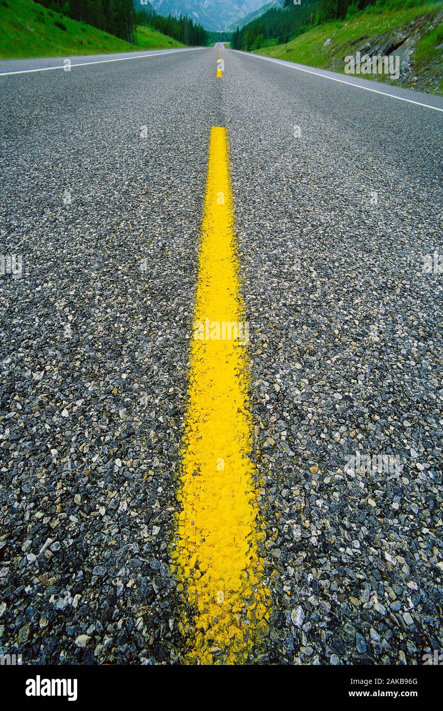 Landscape with surface level view of asphalt road with yellow line Stock Photo