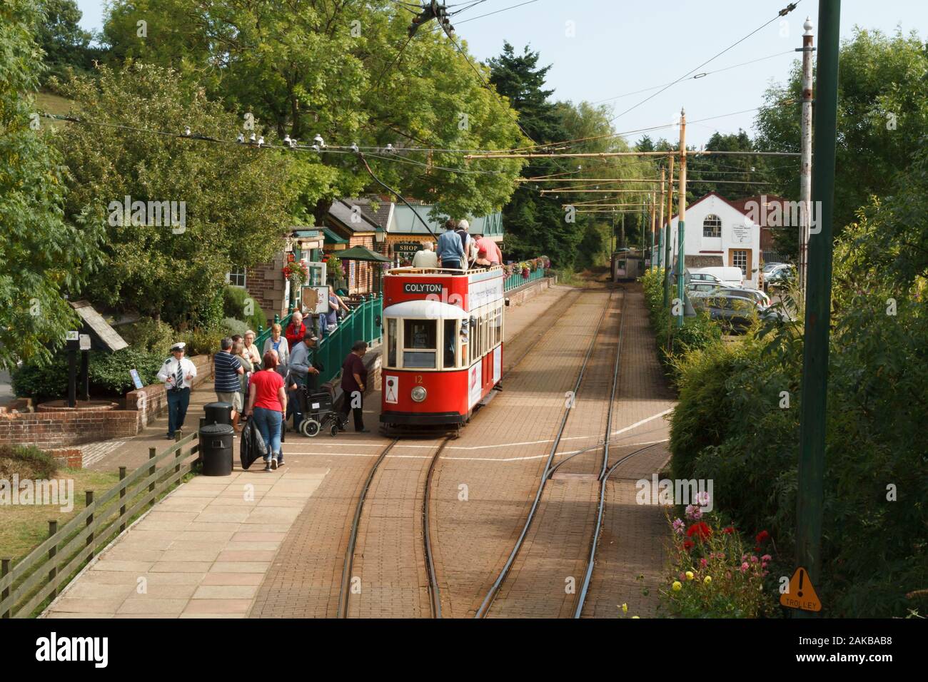 Historic open top electric tram taking passengers to Colyford village Station in the Axe Valley Dorset Stock Photo