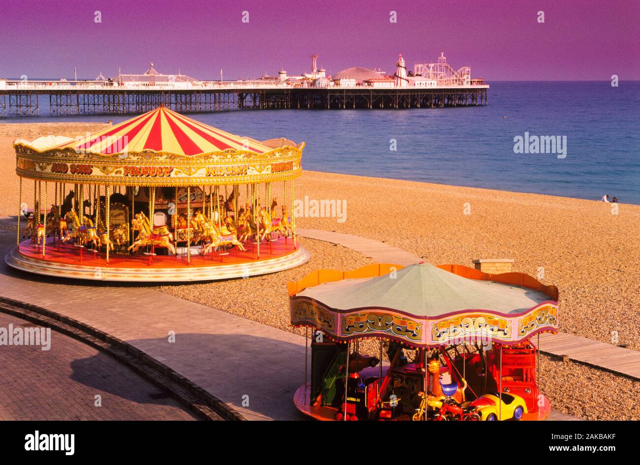 View of carousels on beach, Brighton, England, UK Stock Photo