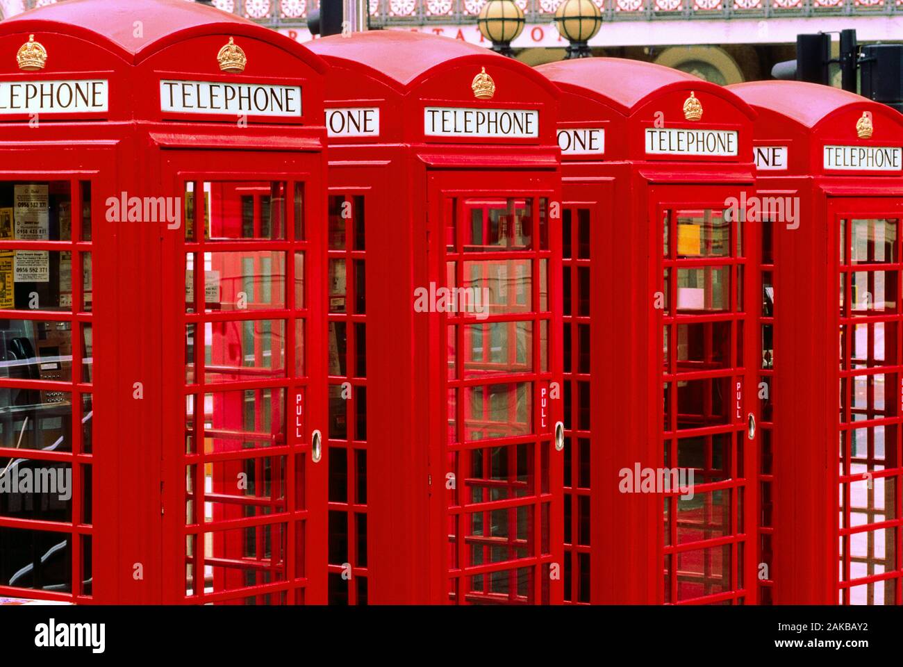 Group of red telephone booths on street, London, England, UK Stock Photo