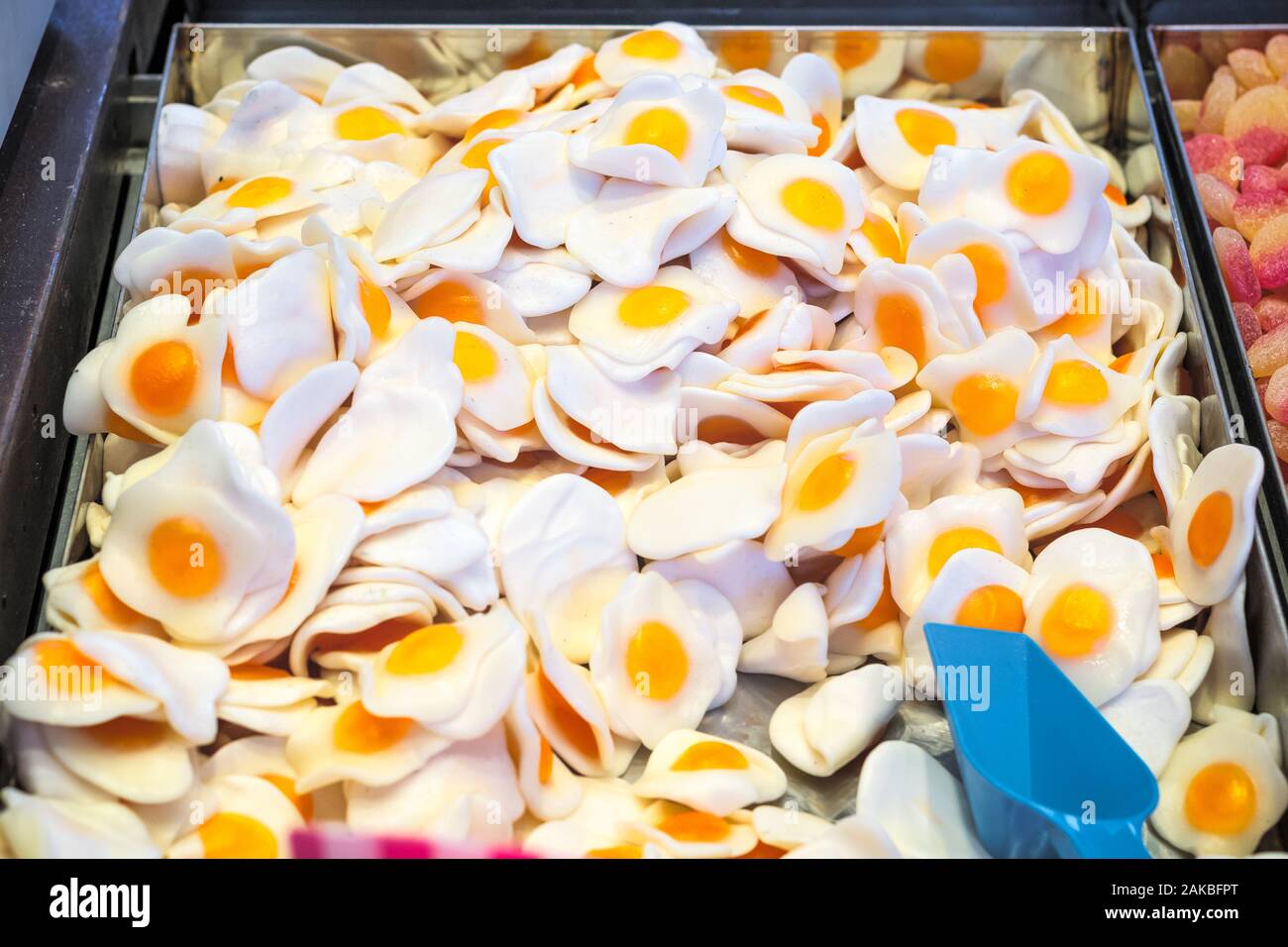 Selective focus, fried eggs soft jelly sweet on display at Christmas market in winter wonderland of London Stock Photo