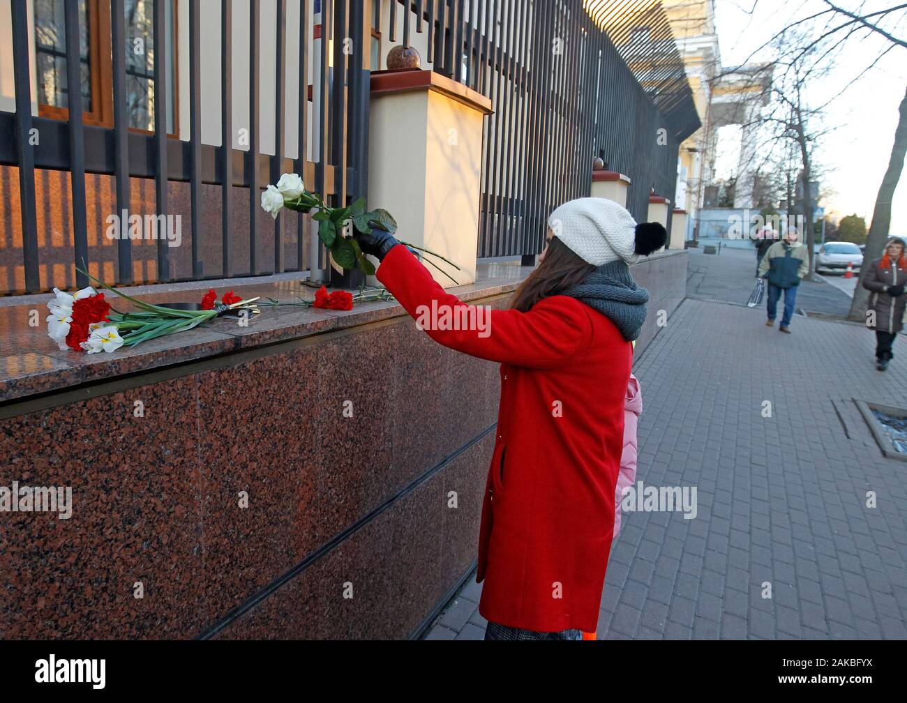 A Woman lays flowers in memory of victims of the Boeing 737 crash in Iran close to the Embassy of Canada. Ukrainian Boeing 737 crashed after taking off from Tehran's airport on 8 January 2020, as media reported. Stock Photo