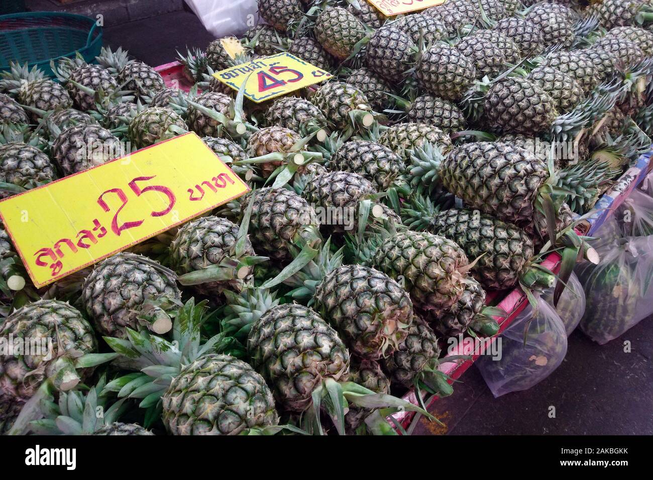 Pineapples for sale in Khlong Toei fresh market, Bangkok, Thailand Stock Photo