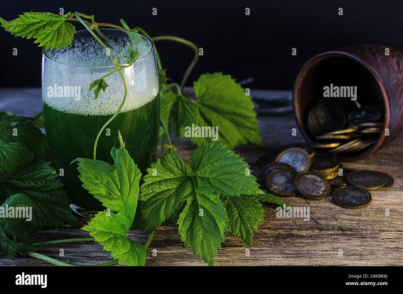 Holiday St. Patrick's Day. Green beer with a hop branch on a gray wooden background with copy space. March 17. Stock Photo