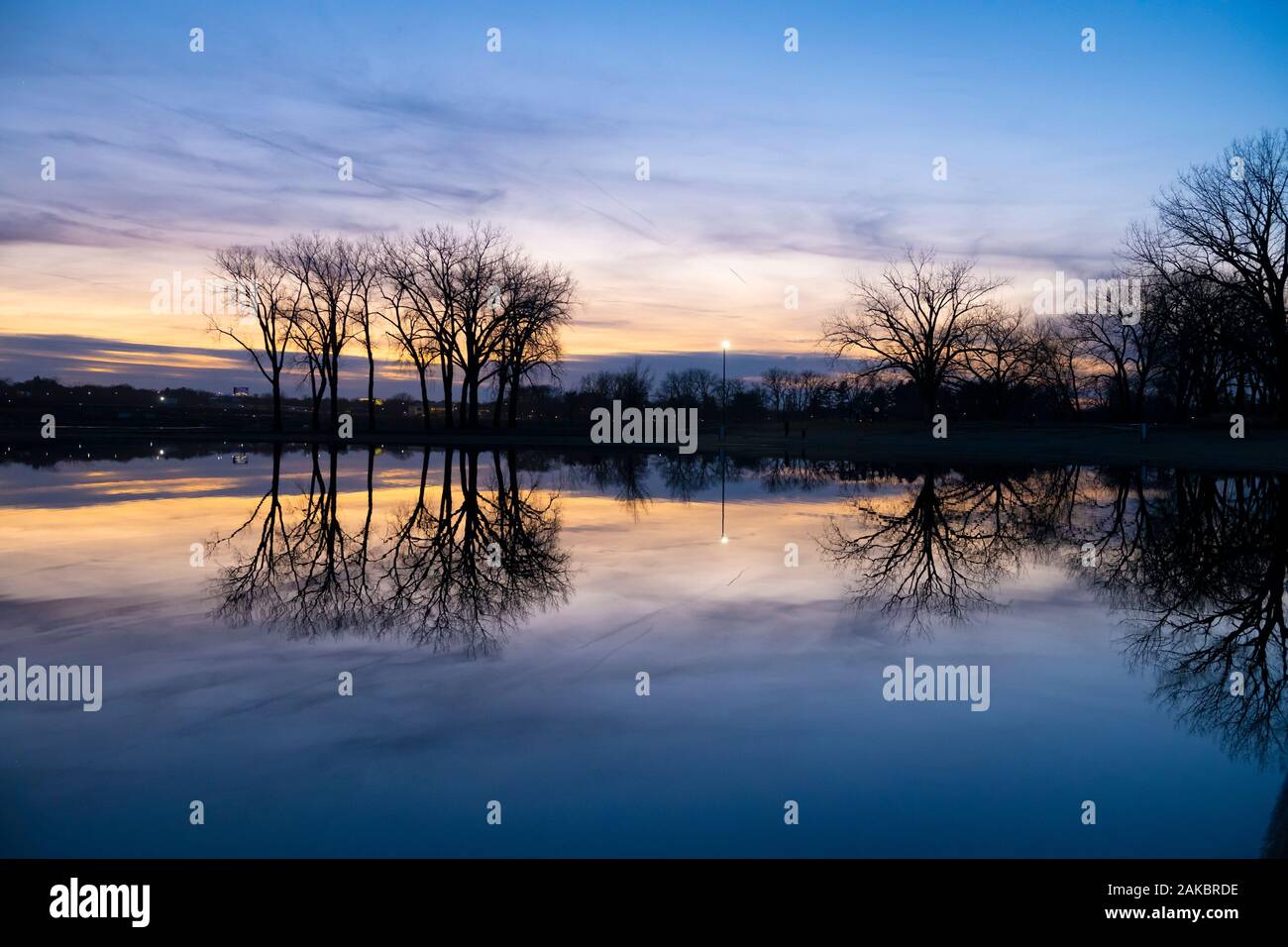 Sunset reflection on calm lake Stock Photo