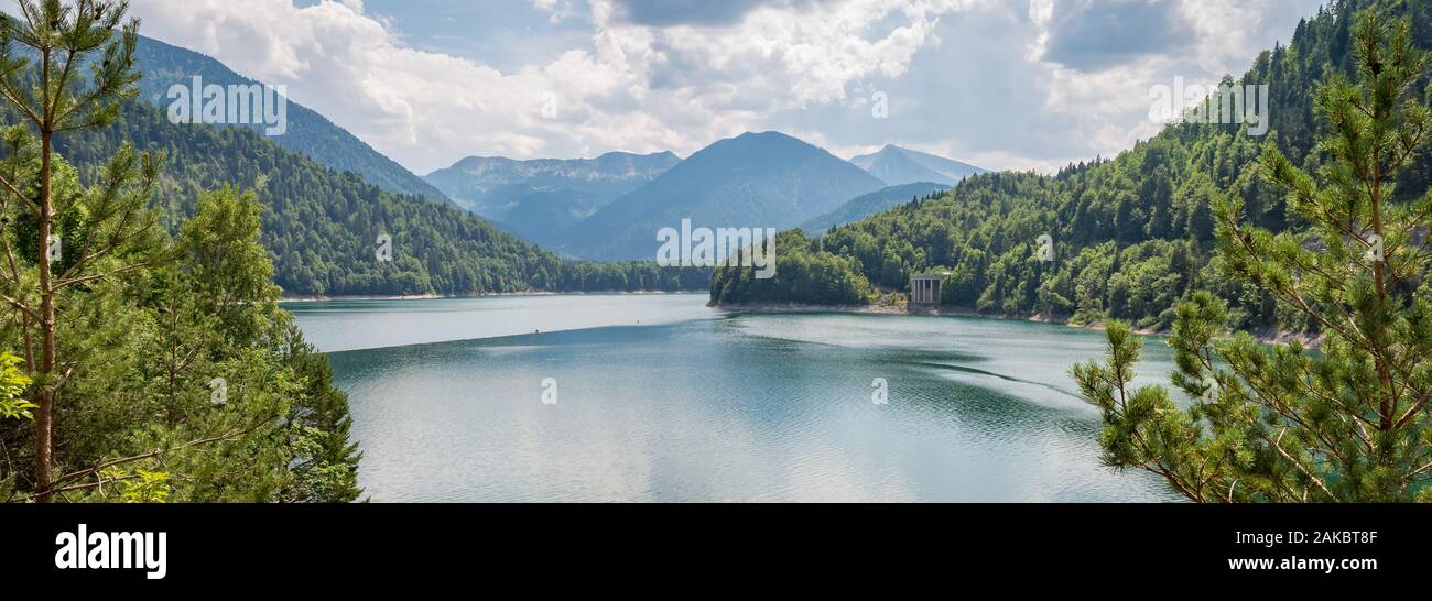 Panorama of a lake in the mountains at the border of Austria and Germany. Beautiful soft reflections in the water. Stock Photo