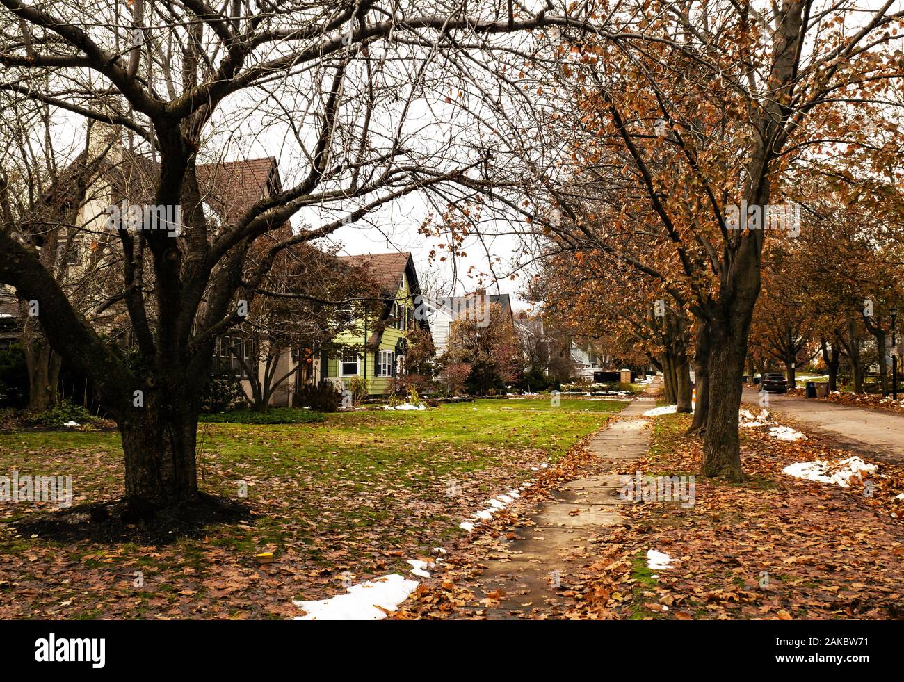 sidewalk through a pretty residential community in autumn Stock Photo