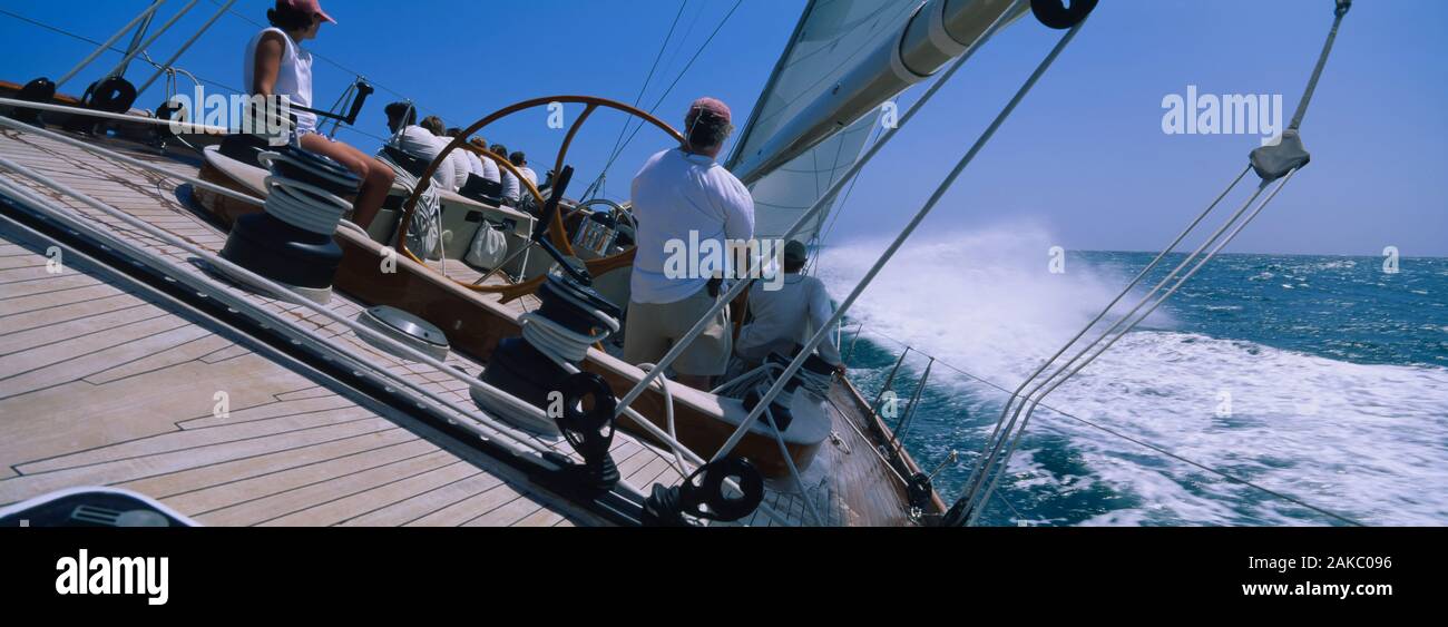 Group of people racing in a sailboat, Grenada Stock Photo