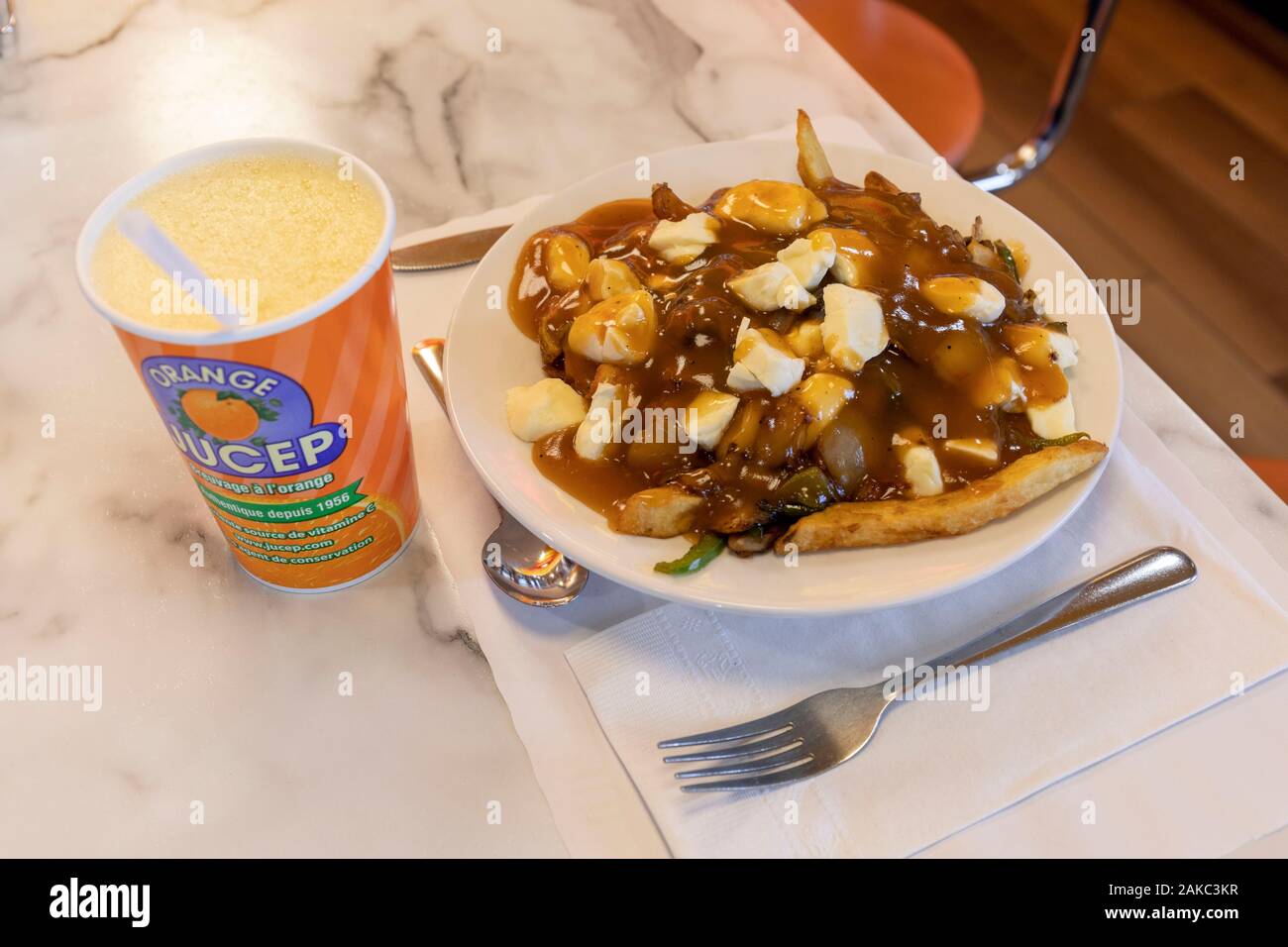Canada, Province of Quebec, Centre-du-Québec region, in the footsteps of the invention of poutine, Drummondville, Le Roy Jucep restaurant, a poutine and and a Jucep Orange drink Stock Photo