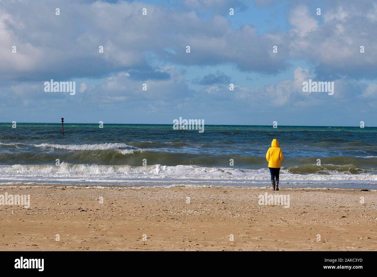 Woman wearing yellow raincoat hi-res stock photography and images - Alamy