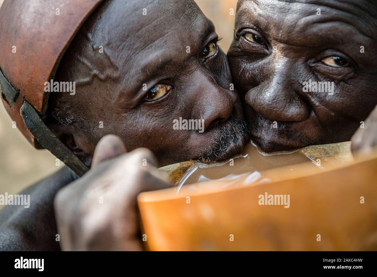 Benin, Nothern distict, Atacora mountains area, Copargo, Taneka tribe traditional healers drinking together millet beer called Tchoukoutou Stock Photo