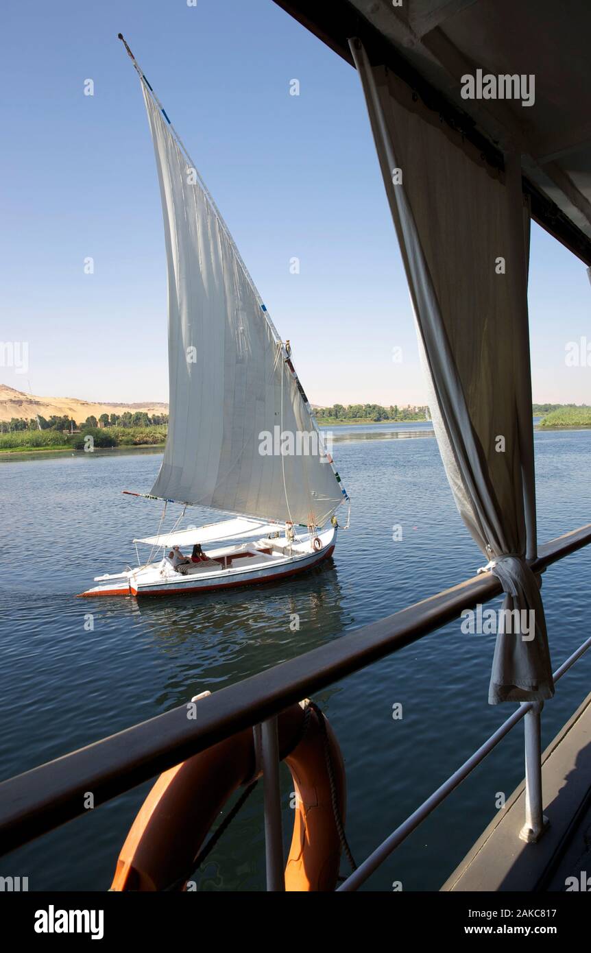 Egypt, Upper Egypt, Nile Valley, felucca all sails out, crossing the Nile, from a passageway of Steam Ship Sudan, the last steamboat on the Nile Stock Photo