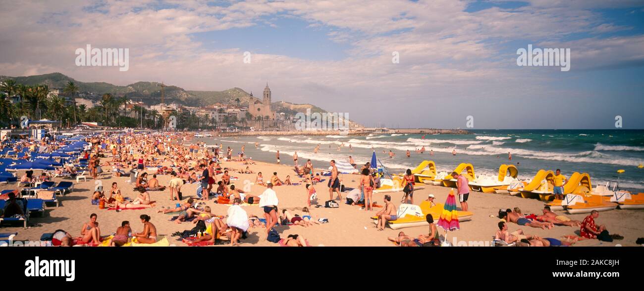 Tourists on beach, Sitges, Spain Stock Photo