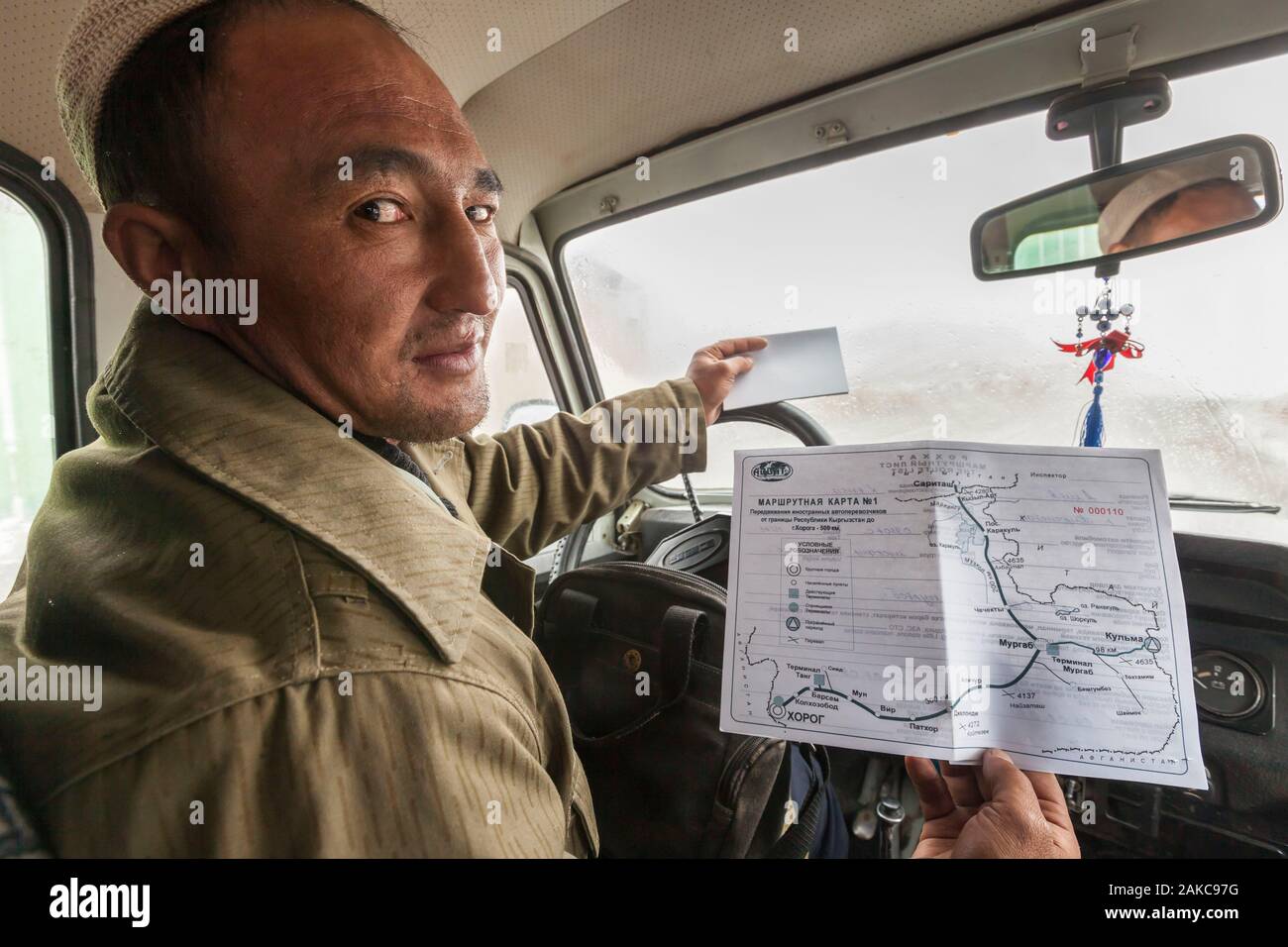 Tajikistan, Gorno-Badakhshan Autonomous Region, Kyzyl-Art Pass, Pamir Highway, border between Kyrgyzstan and Tajikistan, driver showing M41 road, also called Pamir Highway, on the permit issued by the OVIR, immigration and border police Stock Photo