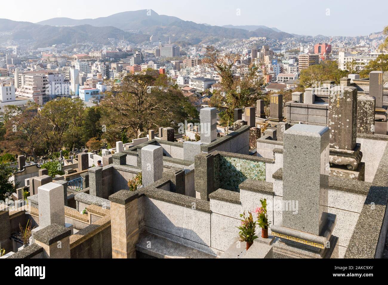 Japan, Kyushu Island, Nagasaki Region, Nagasaki City, Sakamoto International Cemetery, graves, epitaphs and city in the background Stock Photo