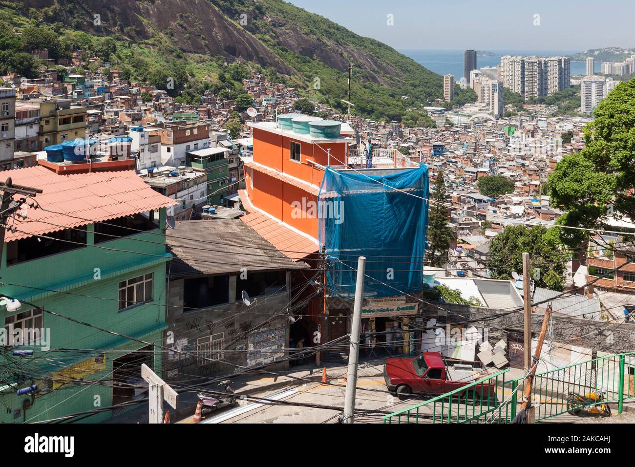 Brazil, state of Rio de Janeiro, city of Rio de Janeiro, favela Rocinha, Carioca landscapes between the mountain and the sea classified UNESCO World Heritage, elevated view of a favela street and the sea in the background Stock Photo