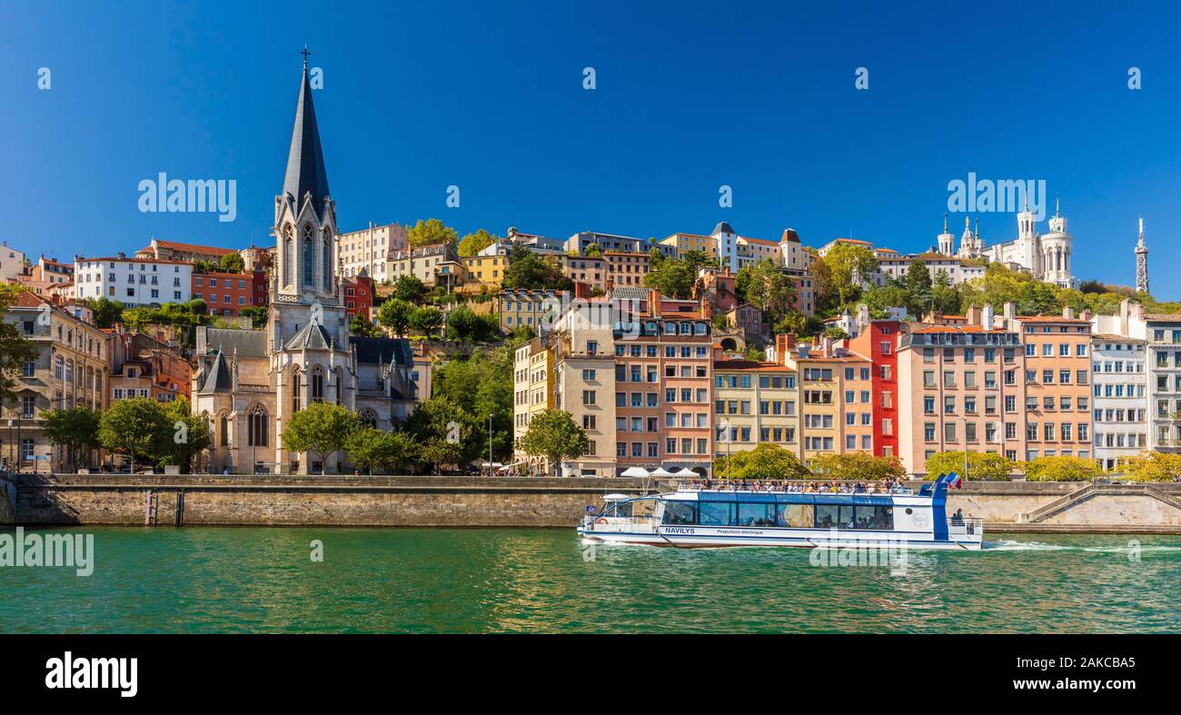 France, Rhone, Lyon, historic district listed as a UNESCO World Heritage site, Old Lyon, Quai Fulchiron on the banks of the Saone river, Saint Georges church and the Notre-Dame de Fourviere basilica on the Fourviere hill, electric propulsion restaurant boat Stock Photo