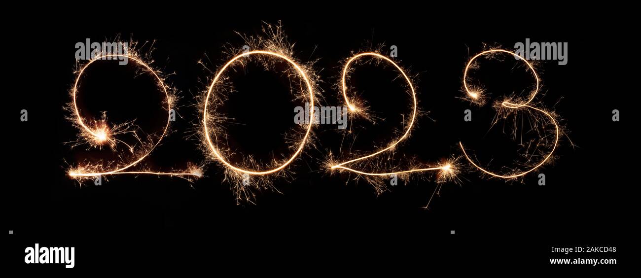 Happy New Year 2023. Number 2023 written sparkling sparklers isolated on black background With Copy Space For Text. Beautiful Glowing overlay template Stock Photo