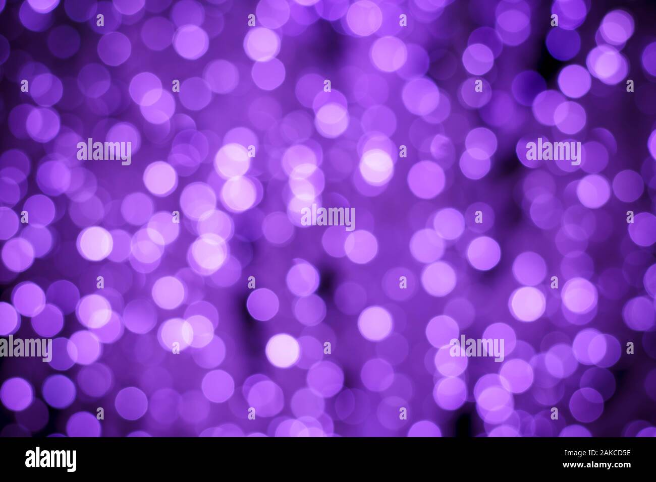 Abstract purple background with night lights of bokeh. Blurred backdrop, defocused shiny circles. Texture with illuminated effect Stock Photo