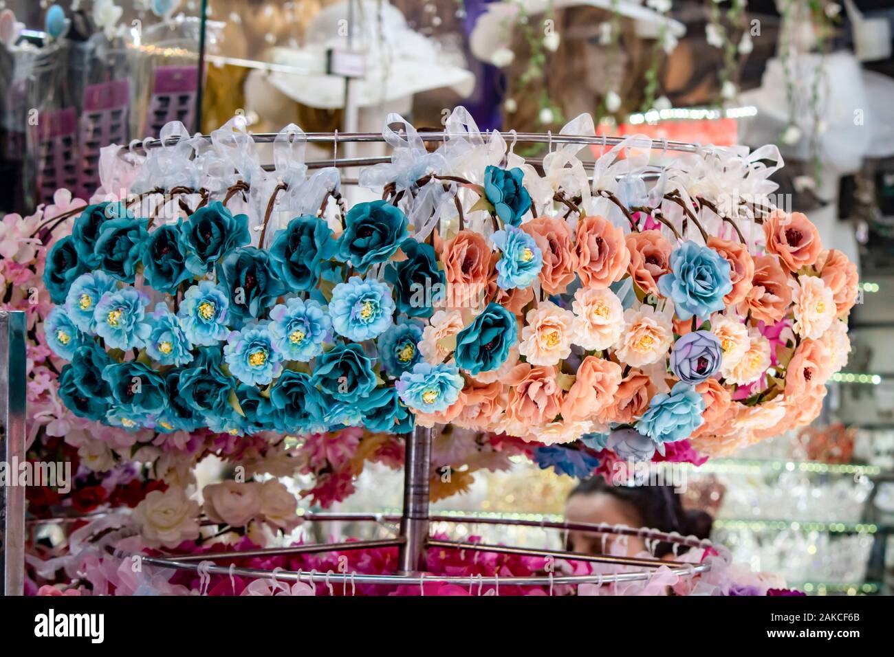 Head crown. Store front hanging on metal shelves. There are fake textile  flowers on the crown Stock Photo - Alamy