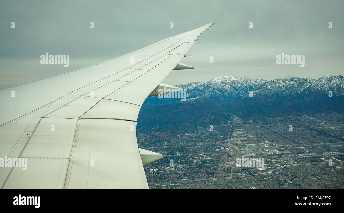 Landing in LAX, Los Angles, Air Canada 787 Jet is taking off from YYZ over develop housing land, it shows the growth of Toronto. Stock Photo