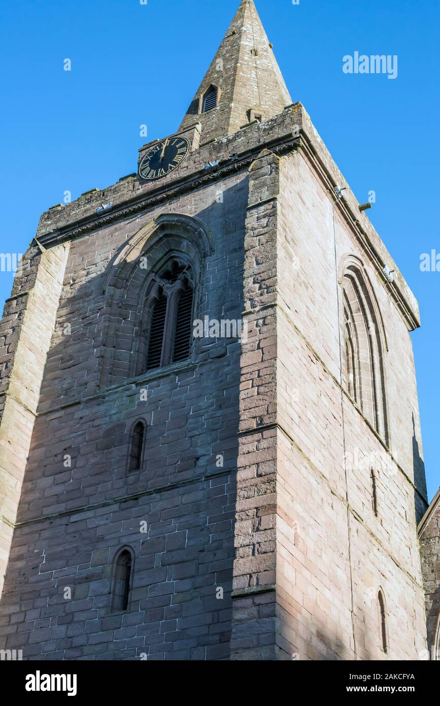 Large square tower and clock face of Brechin Cathedral, Angus, Scotland, UK. with arched Gothic windows. Stock Photo