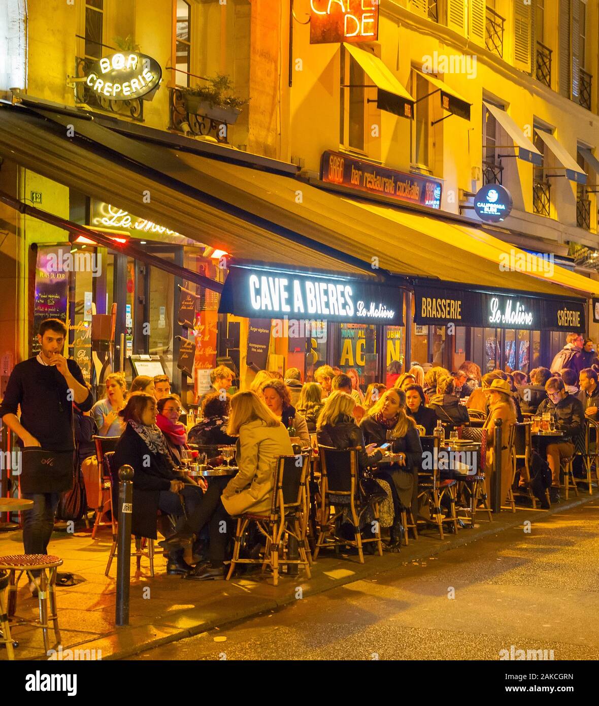 PARIS, FRANCE - NOVEMBER 09, 2018: People at a street restaurant in Paris at night. Paris is the most visited city in Europe Stock Photo