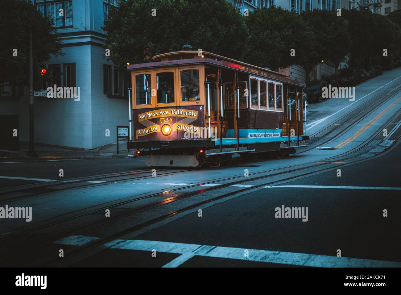 Magical twilight view of historic Cable Car riding on famous California Street at dawn before sunrise, San Francisco, California, USA Stock Photo