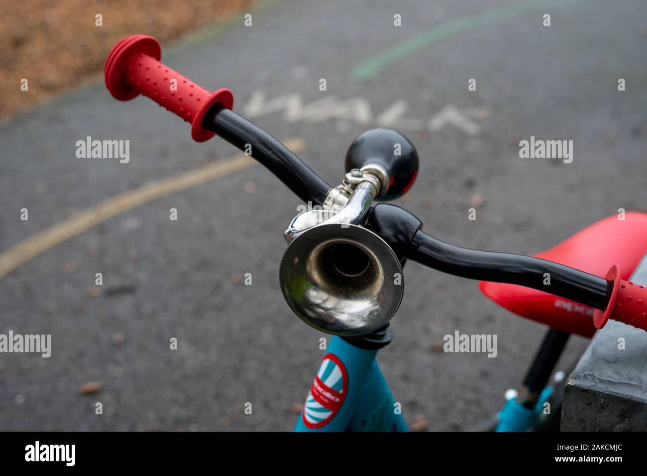 A close up of a horn on the handle bars of a child's bicycle Stock Photo