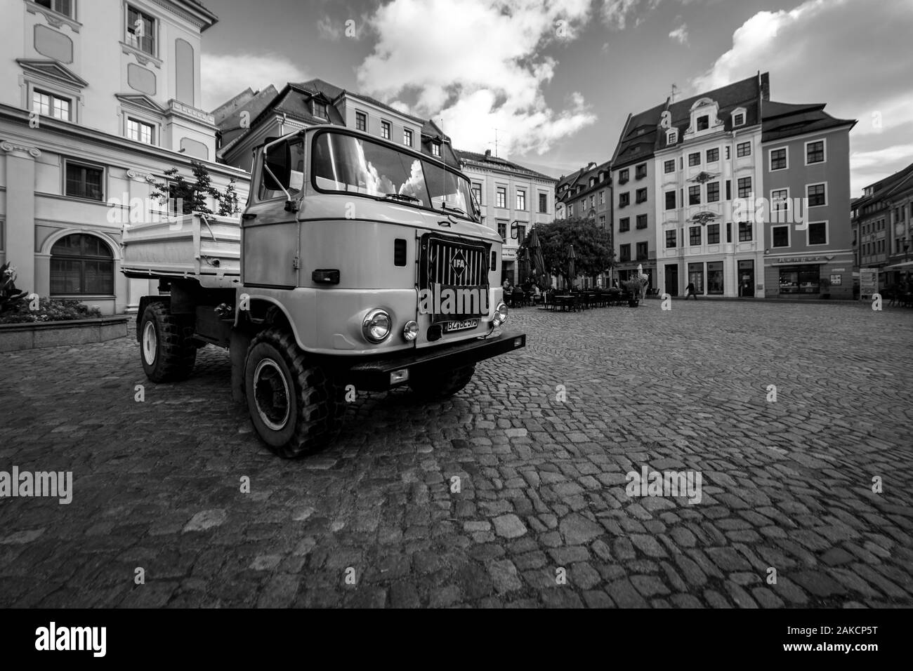 BAUTZEN, GERMANY - OCTOBER 10, 2019: City Hall Square and a medium-duty truck IFA W50 in the foreground. Black and white. Stock Photo