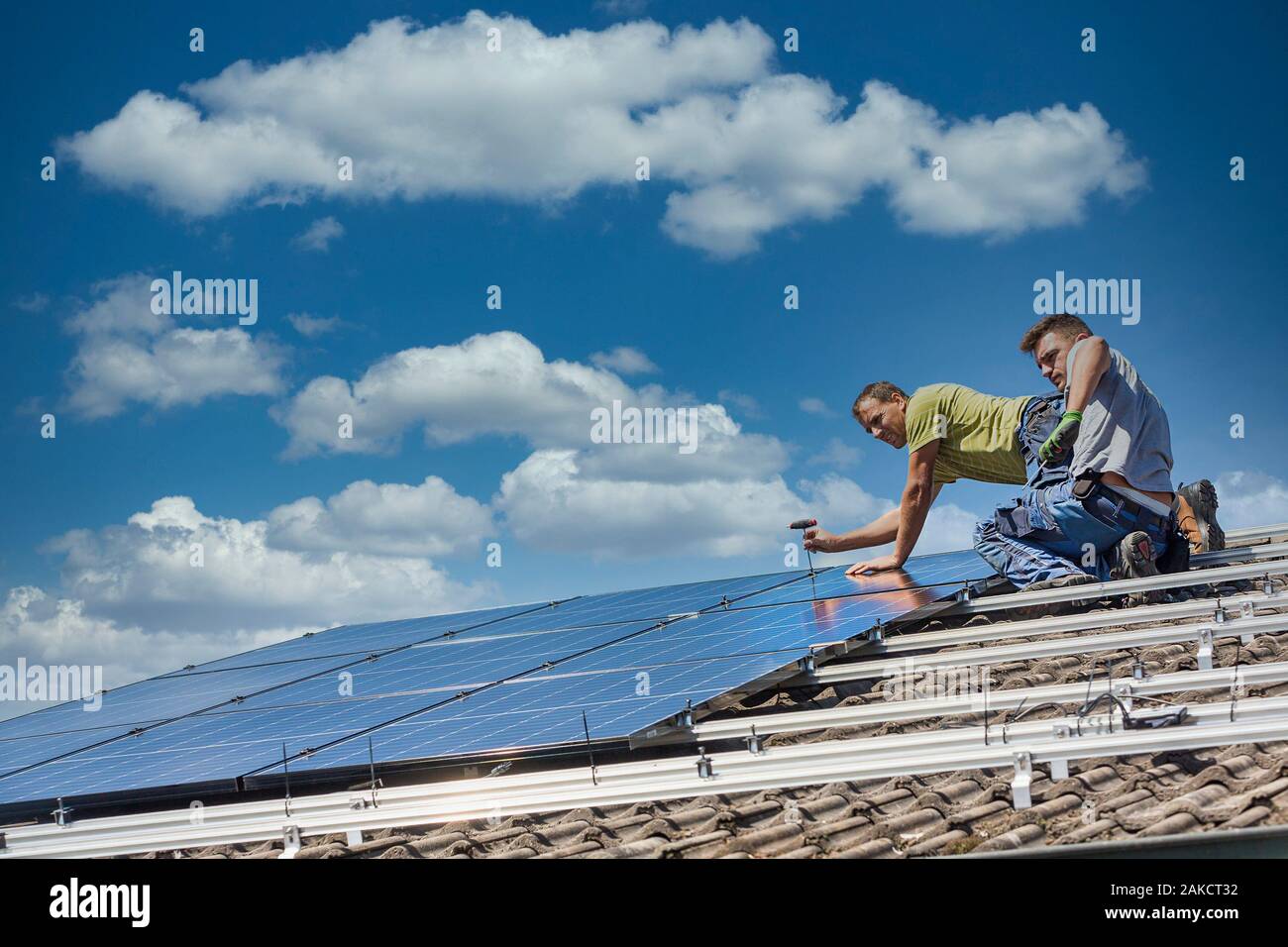 Installing solar photovoltaic panel system. Solar panel technician