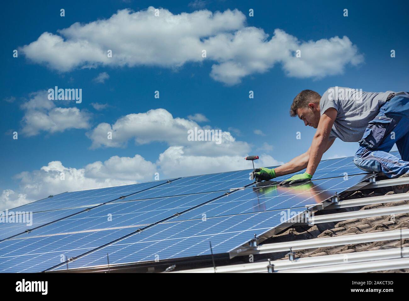 Installing solar photovoltaic panel system. Solar panel technician