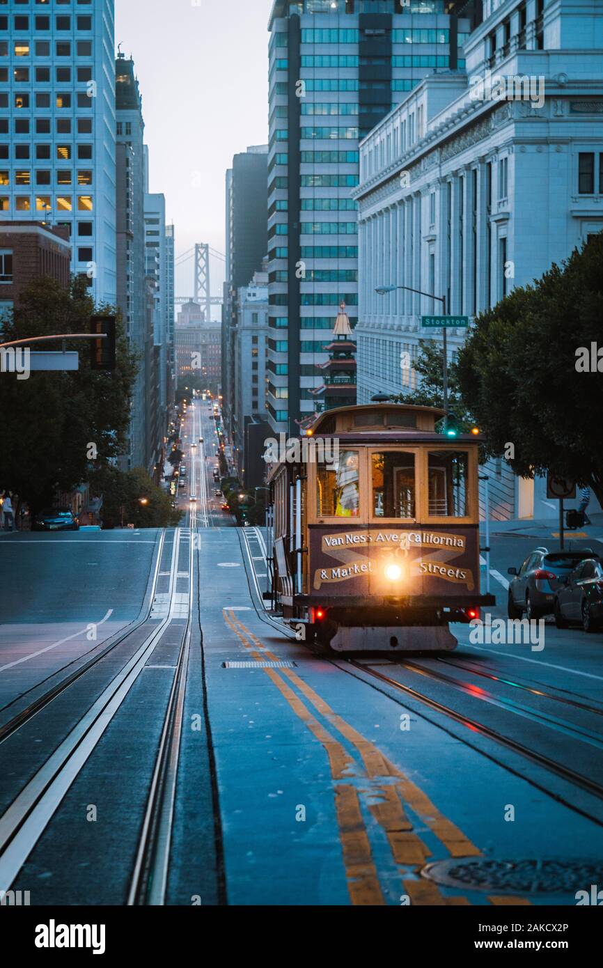 Historic Cable Car riding on famous California Street in beautiful early morning twilight before sunrise in summer, San Francisco, California, USA Stock Photo
