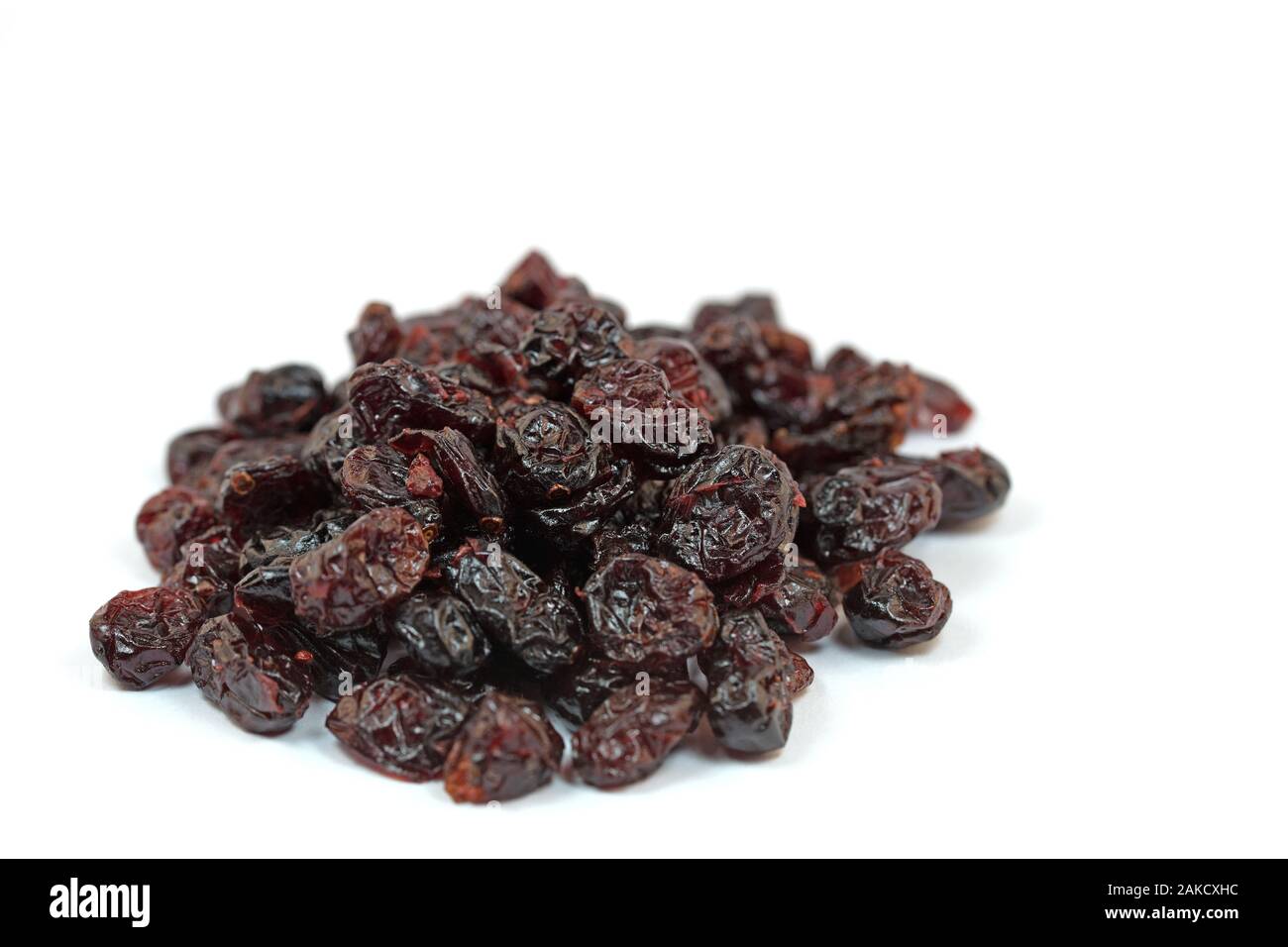 Dried cranberries, Vaccinium macrocarpon, against white background Stock Photo