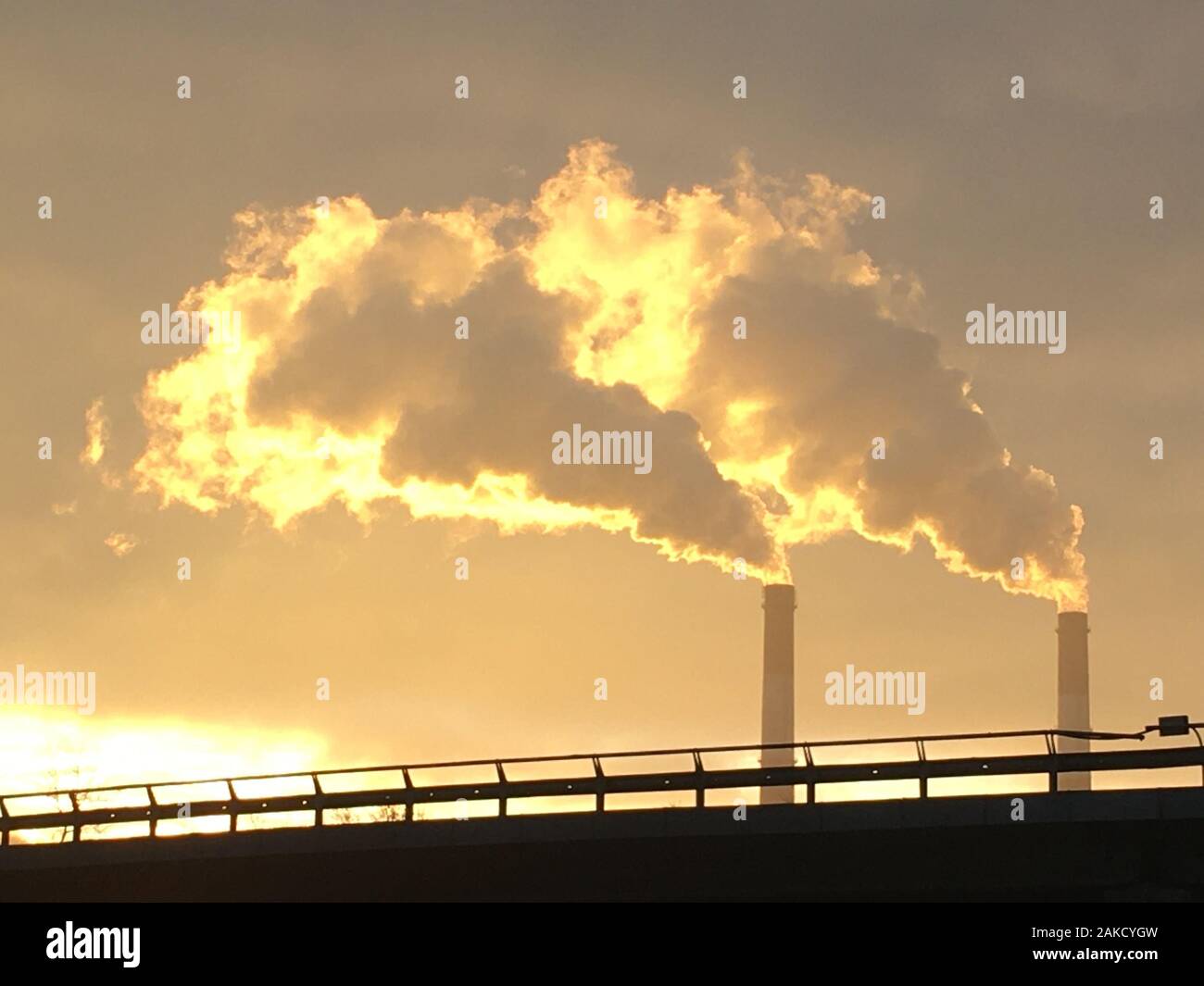 Photo of ecological pollution of industrial zone of Kyiv city. Air pollution by heavy industry in the morning at sunrise in winter Stock Photo